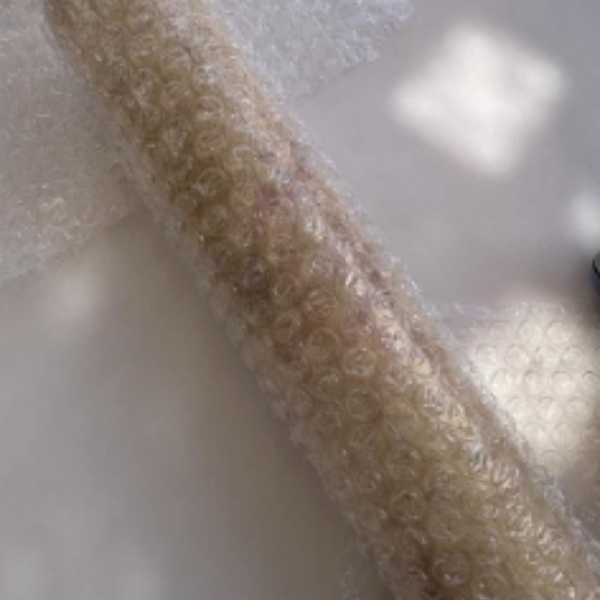 Bubble wrap wrapped around a rolling pin.