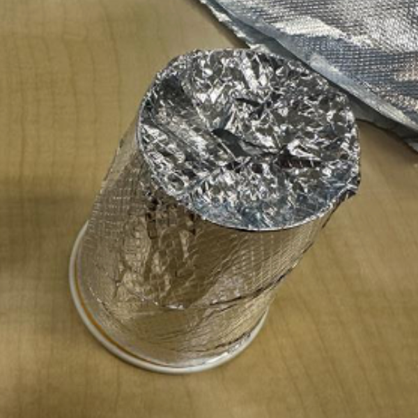 A paper cup covered in foil.