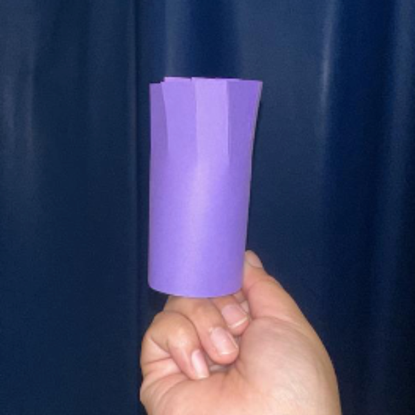 Purple paper rolled into a tube shape.