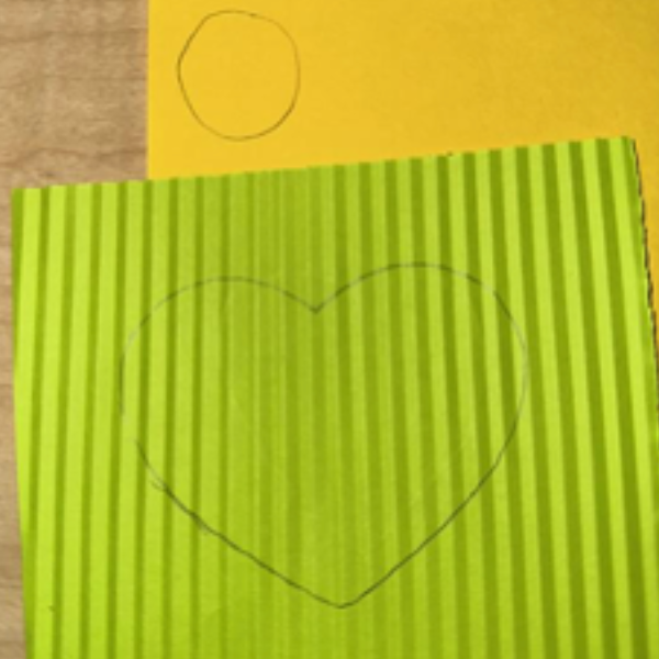 A green crinkled paper with a drawn heart shape.