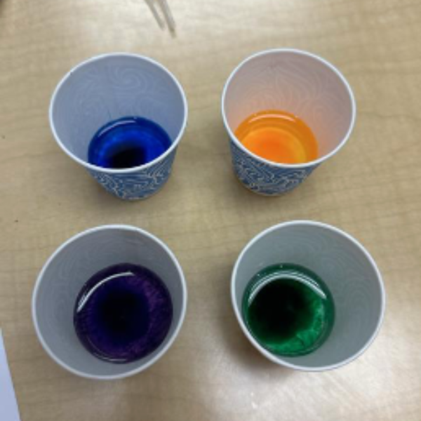 Cups of food coloring and water.