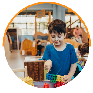 small boy playing with connecting blocks