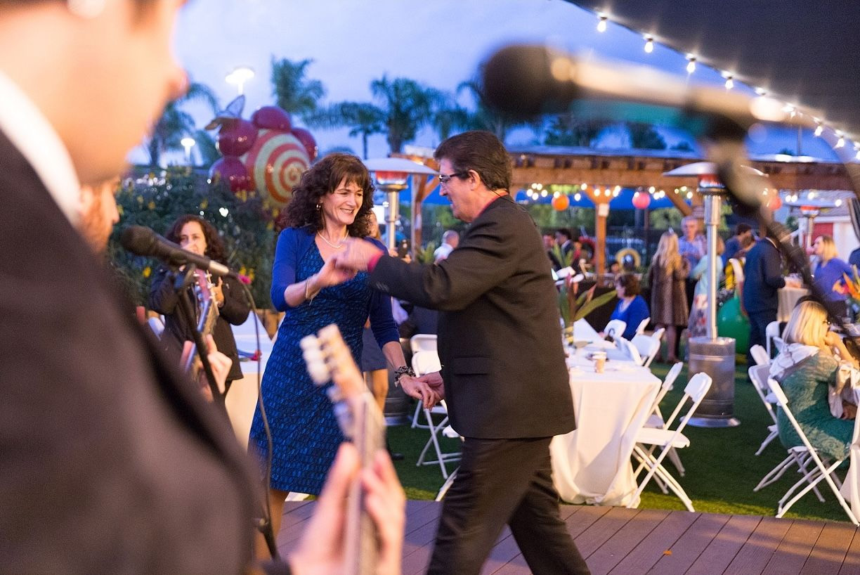 woman and man dancing together on dance floor at event