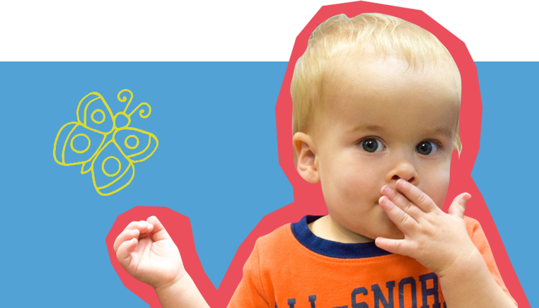 toddler at SDCDM with hand over mouth looking at camera