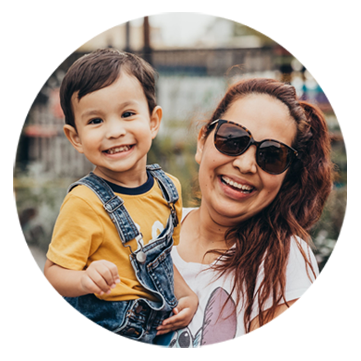 woman holding a child and both smiling