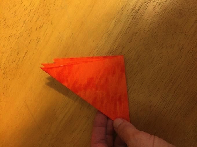 Paper folded into small triangle