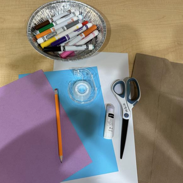 Materials to make a paper bag backpack.