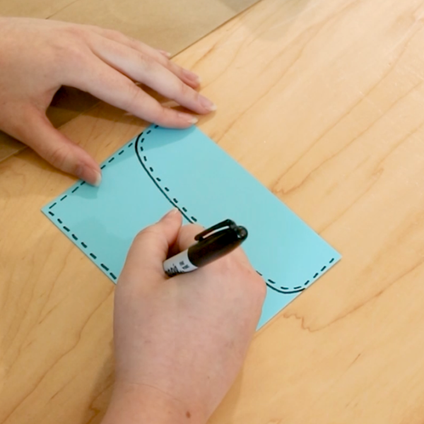 Small dashes are drawn on a blue sheet of paper.