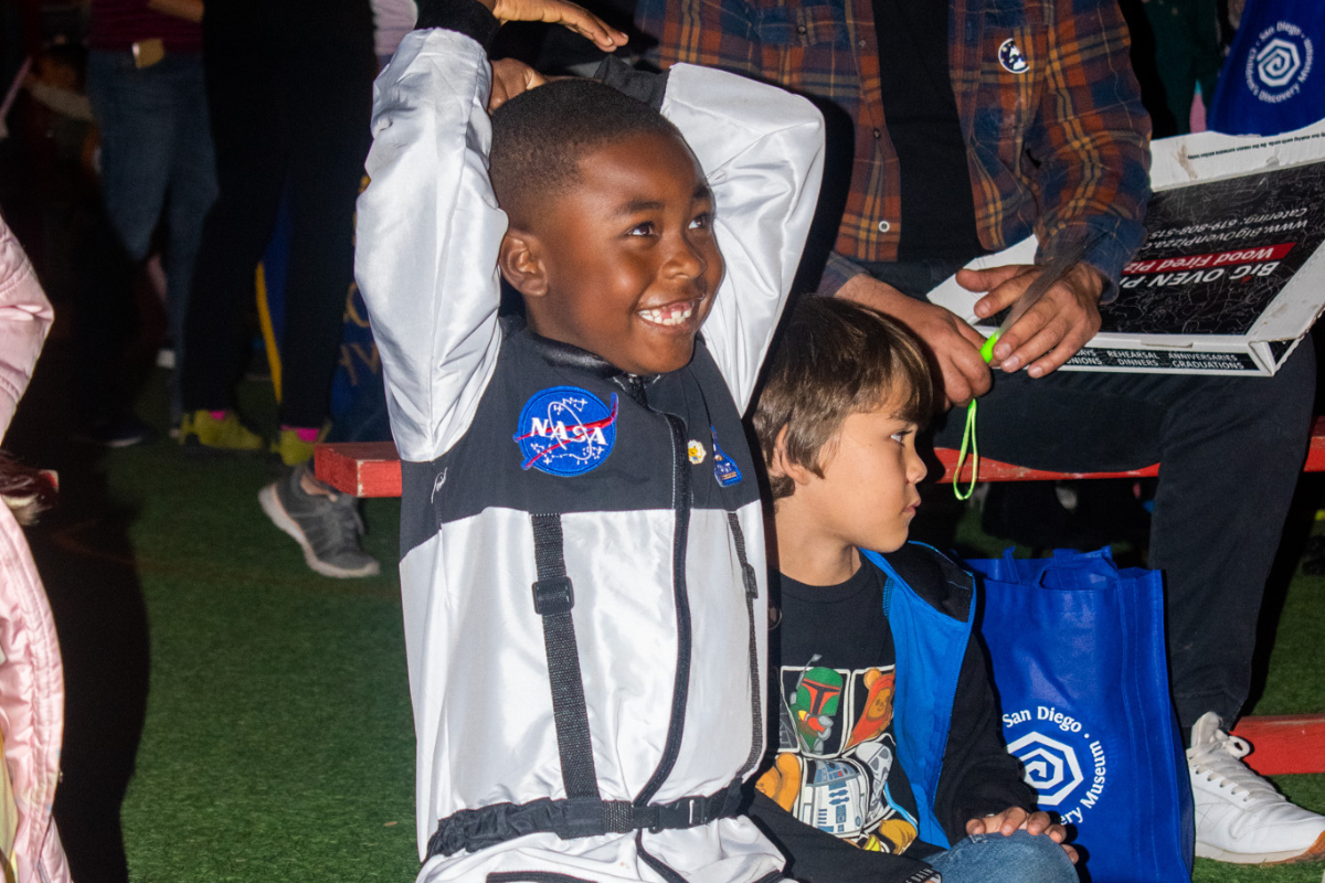 Kid in an astronaut costume at Space Night.