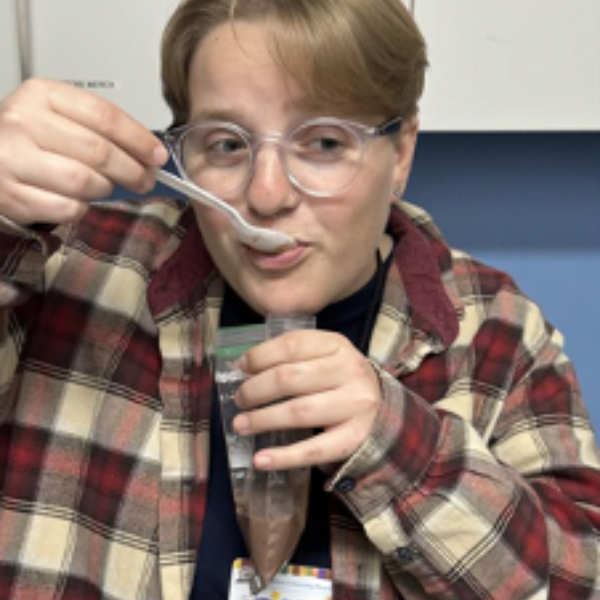 An educator eating the astronaut pudding.