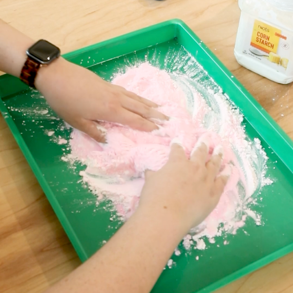 Craft sand and cornstarch mixed on a tray.