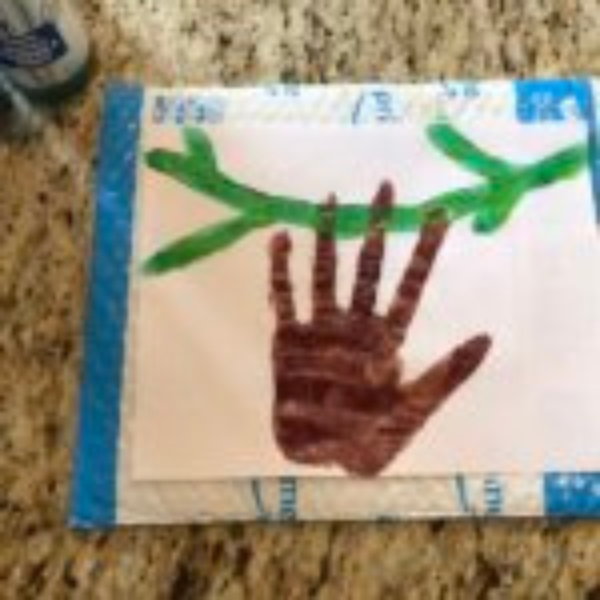 Brown handprint on piece of paper.