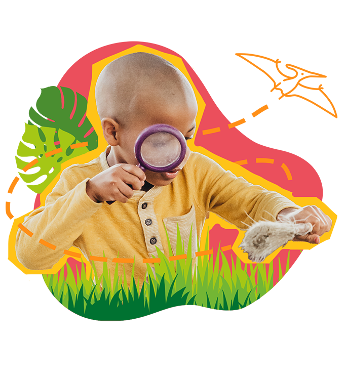 child looking through magnifying glass at paintbrush